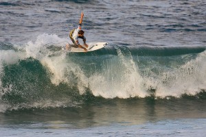 A surfer on the beach Mundaka in Vizcaya